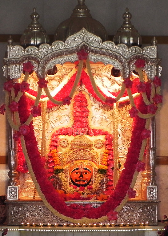 Hanuman sits to the right front.